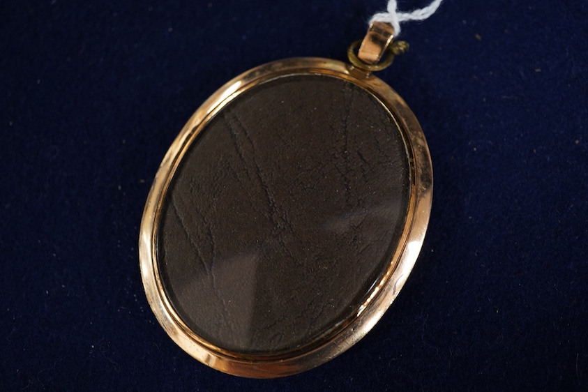 Regency School, Portrait miniature of a young gentleman wearing a frock coat, oval watercolour on ivory, 6 x 4.5cm, housed in a gilt metal pendant frame CITES Submission reference K7AFBZFN